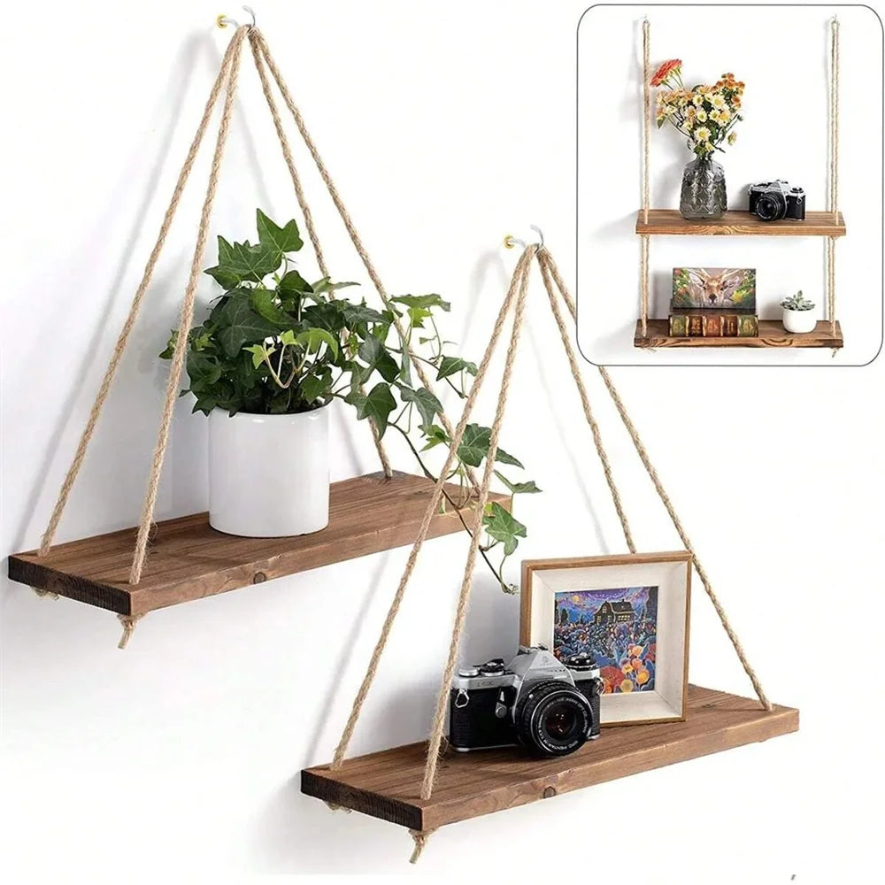 Two swing hanging pine shelves on a wall with a trailing plant and framed photo