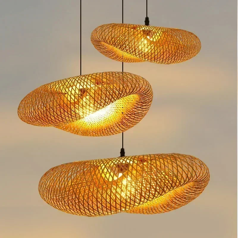 Two hand-woven bamboo saucer pendants glowing warm amber
