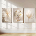 Three peony prints above a bed