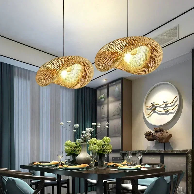 Bamboo saucer pendant hanging over a dining table in a warm interior