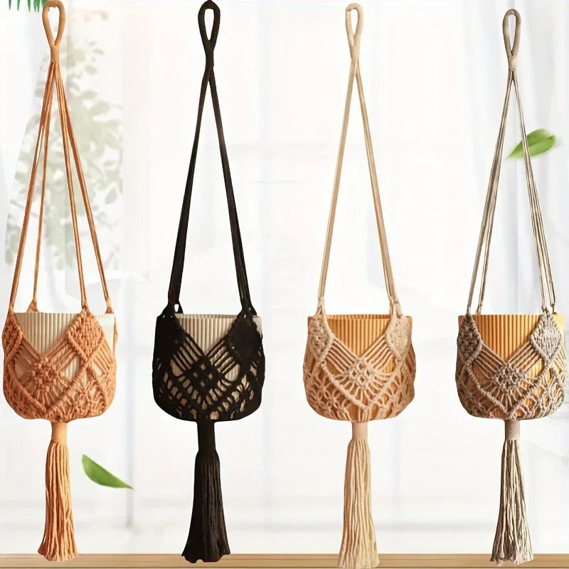 Four macrame plant hangers in cream, black, khaki and grey against a bright window
