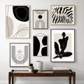 Three framed abstract line prints on a wall