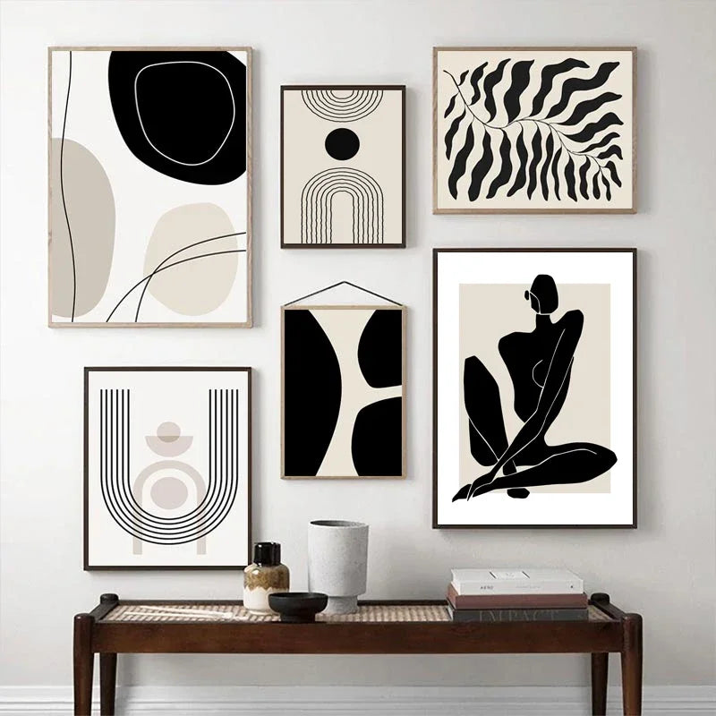 Three framed abstract line prints on a wall