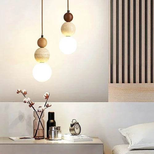 Travertine pendants over a bedside table