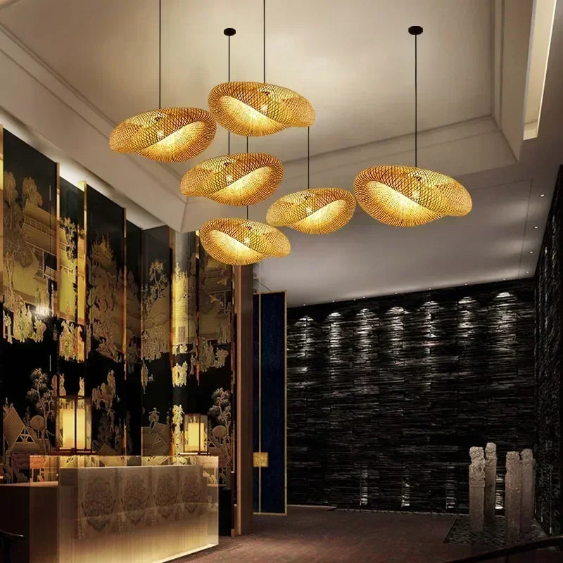 Row of woven bamboo saucer pendants lighting a long room