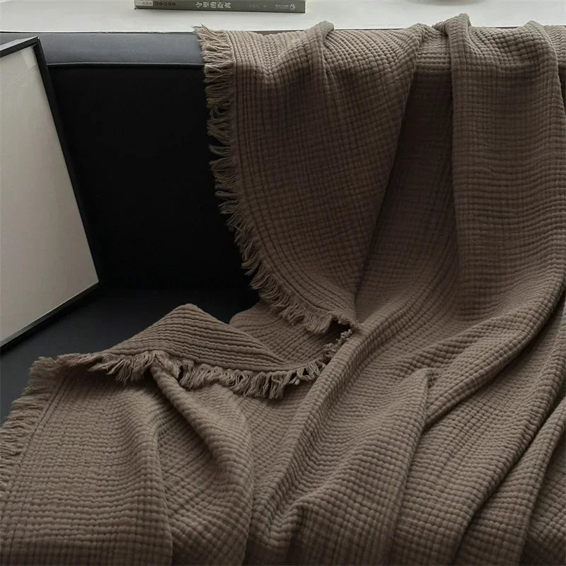 Knotted fringe edge of the cocoa cotton throw