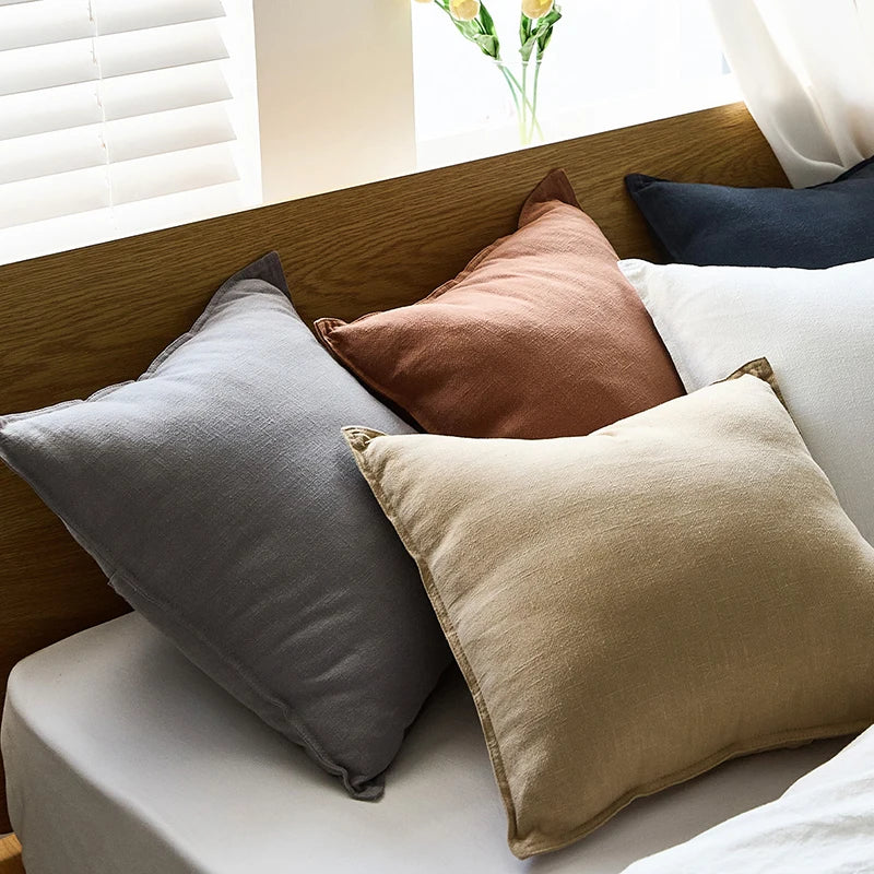 Cushions grouped on a bed showing the colour range
